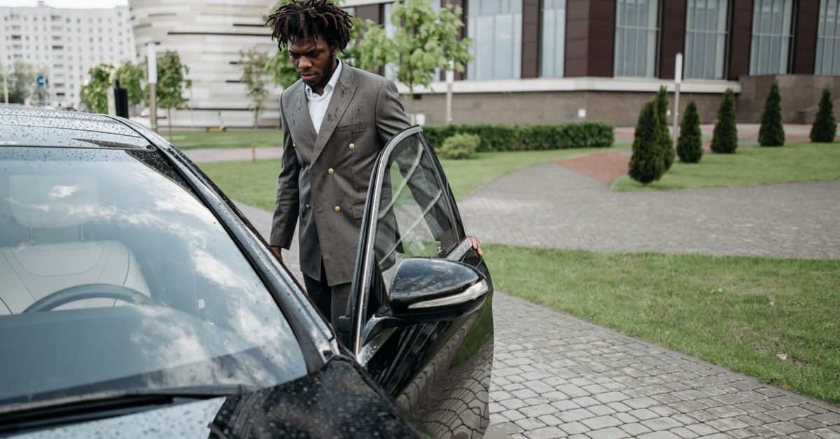 Chauffeur opening the door of an executive car