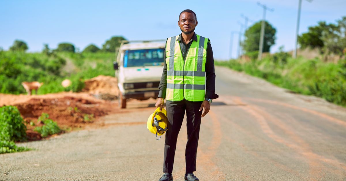 Worker in a high-visibility vest on a road in Nigeria